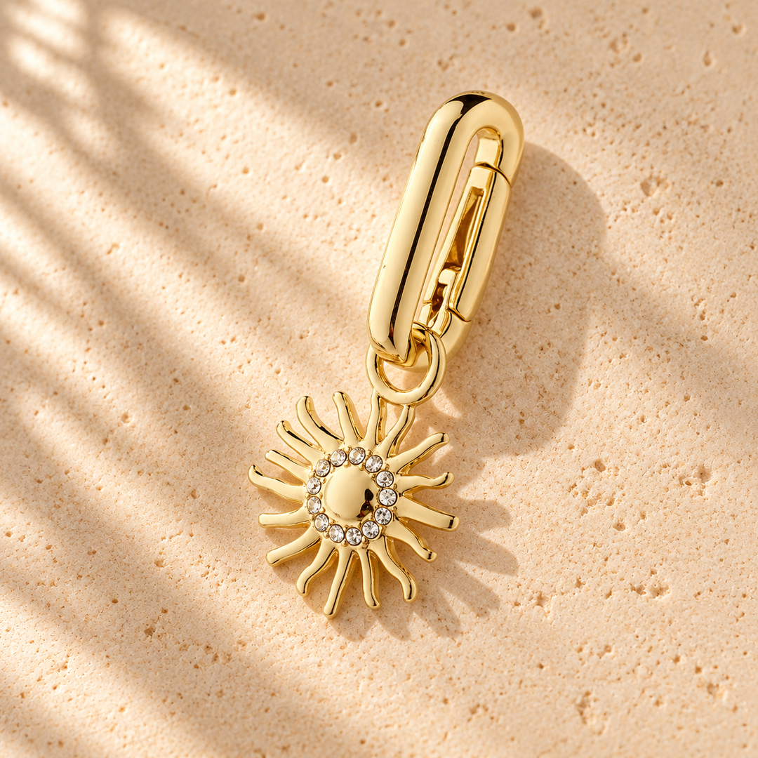 G. D’Aoust | Jewelry / Charms & Pendants | CHARM RECYCLED SUN PENDANT GOLD-PLATED on warm limestone